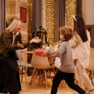 Two kids giving gifts to their mother on a special occasion
