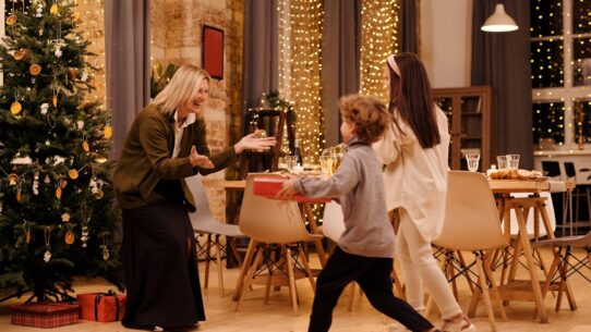 Two kids giving gifts to their mother on a special occasion