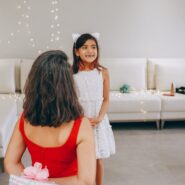 Mother giving her daughter a beautifully wrapped Christmas present